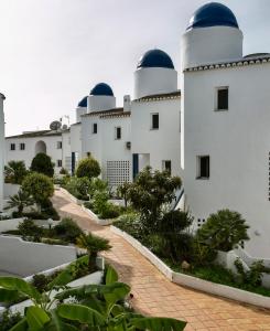 a row of white buildings with domes on them at Ona Campanario in La Cala de Mijas