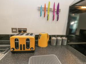 an orange toaster sitting on top of a kitchen counter at Sea Glass in Filey
