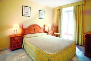 a bedroom with a large bed and a window at Ona Campanario in La Cala de Mijas