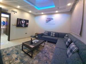 a living room with a couch and a table at Kayan Apartments in Jeddah