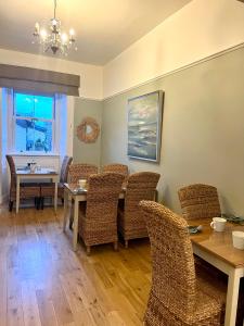 a dining room with a table and chairs at ByTheSea Guest House in Ayr