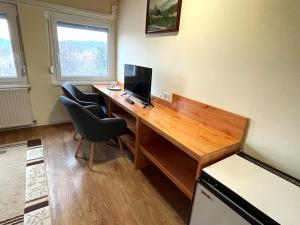 an office with a desk with a computer and two chairs at Kántás Vendégház Tihany in Tihany +29 photos