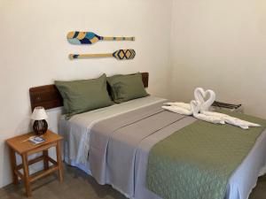 a bedroom with a bed with a baseball bat on the wall at Club Manguaba Beira Rio Mar in Japaratinga