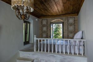 a bedroom with a crib and a window at Melitia Traditional House in Koskinou