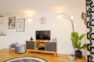 a living room with a flat screen tv on a table at Victoria Apartment 3 in Torquay