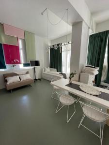 a living room with a white table and chairs at Main Station Design Loft Style Apartment in Innsbruck