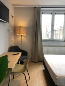 Postel nebo postele na pokoji v ubytování Hotel Le Cygne d'Argent