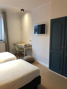 Postel nebo postele na pokoji v ubytování Hotel Le Cygne d'Argent