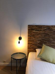 Postel nebo postele na pokoji v ubytování Hotel Le Cygne d'Argent