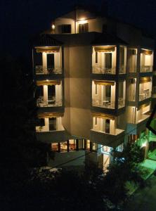 an apartment building at night with its lights on at Aiolos in Loutra Edipsou
