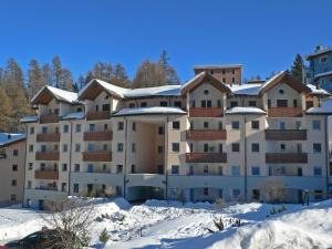 a large apartment building with snow on the ground at Apartment Chesa Flora 53 by Interhome in St. Moritz