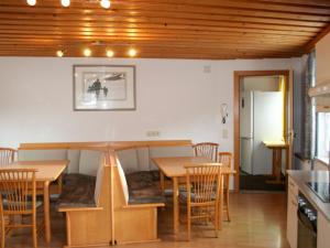 a dining room with wooden tables and chairs at Apartment Helga - TDL113 by Interhome in Tobadill