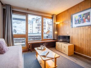 a living room with a couch and a tv and a table at Apartment Le Grand Tichot A et B-2 by Interhome in Tignes