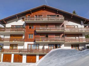 a large building with a snow ramp in front of it at Apartment Stem 2 by Interhome in Verbier