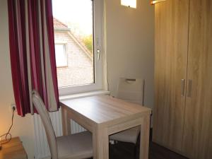 a small room with a table and a window at Holiday Home Tossens-5 by Interhome in Butjadingen OT Tossens