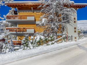 a house in the snow with snow covered trees at Apartment Talisman 7 by Interhome in Verbier