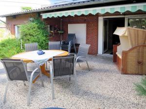 a table and chairs sitting on a patio at Holiday Home Lilly by Interhome in Osteel