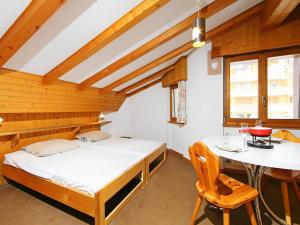 a room with two beds and a table in it at Apartment Eldorado 321 by Interhome in Verbier