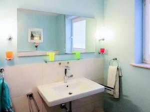 a bathroom with a white sink and a mirror at Apartment Vogesenblick by Interhome in Heiligenzell