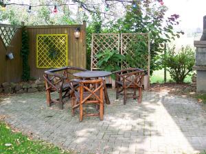 a table and two chairs and a table and a fence at Apartment Vogesenblick by Interhome in Heiligenzell