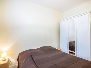 a white bedroom with a bed and a closet at Apartment Orléans by Interhome in Trouville-sur-Mer +14 photos