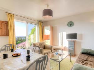 a living room with a table and a couch at Apartment Le Cap Bleu by Interhome in Blonville-sur-Mer