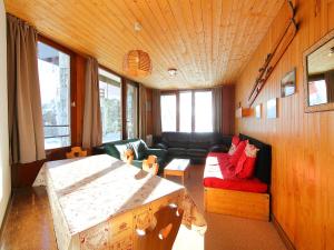 a living room with a table and a couch at Apartment Les Hauts du Val Claret-6 by Interhome in Tignes