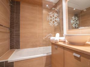 a bathroom with a tub and a sink and a shower at Studio Les Grandes Platières-11 by Interhome in Tignes