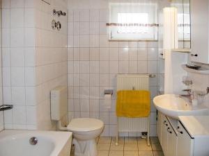 a white bathroom with a toilet and a sink at Apartment Glowe - GLW655 by Interhome in Glowe