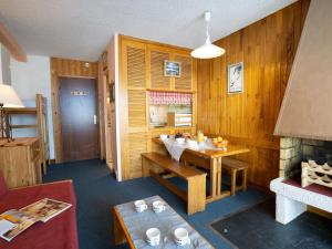 a living room with a table and a dining room at Apartment Le Curling B-20 by Interhome in Tignes