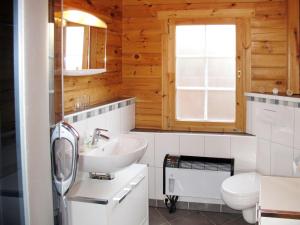a bathroom with a sink and a toilet at Holiday Home Zum Stolpseefischer by Interhome in Himmelpfort