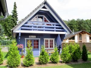 a blue house with trees in front of it at Holiday Home Zum Stolpseefischer by Interhome in Himmelpfort