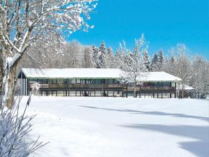 a building covered in snow in a snow covered field at Apartment Siegsdorf by Interhome in Siegsdorf