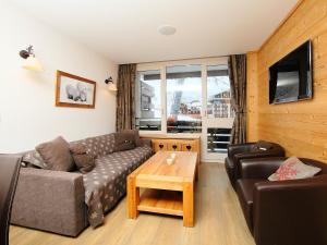 a living room with a couch and a coffee table at Apartment Les Hauts du Val Claret - Val Claret-17 by Interhome in Tignes