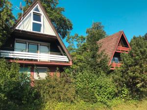 a red house with a gambrel roof at Holiday Home Pfrungen by Interhome in Pfrungen