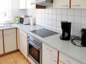 a kitchen with a stove and a sink at Apartment Schwarzwaldblick IV by Interhome in Bernau im Schwarzwald