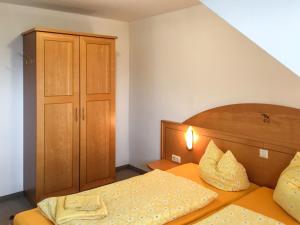 a small bedroom with a bed and a wooden headboard at Apartment Schwarzwaldblick IV by Interhome in Bernau im Schwarzwald