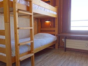 a bunk bed room with two bunk beds and a window at Apartment Les Moutières B1 et B2 - Val Claret-20 by Interhome in Tignes