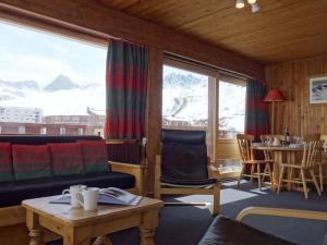 a living room with a couch and a table at Apartment La Grande Casse - Lavachet-3 by Interhome in Tignes