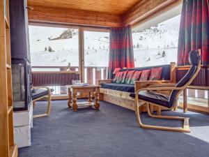 a living room with a couch and chairs and a tv at Apartment La Grande Casse - Lavachet-3 by Interhome in Tignes