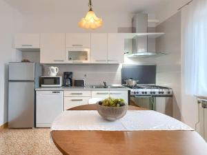 a kitchen with a table with a bowl of fruit on it at Apartment Macini-2 by Interhome in Žminj