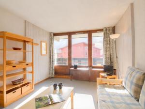 a living room with a couch and a window at Apartment Les Grandes Platières-10 by Interhome in Tignes