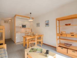 a living room with a table and a kitchen at Apartment Les Grandes Platières-10 by Interhome in Tignes