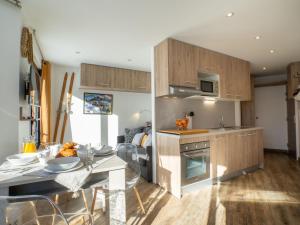 a kitchen and living room with a table and a stove at Apartment Les Tufs - Val Claret-5 by Interhome in Tignes