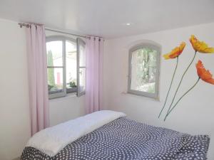 a bedroom with a bed and two windows at Holiday Home La Chartreuse by Interhome in La Môle