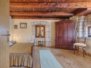 a bedroom with a bed and a wooden ceiling at Holiday Home Jadranka - ROJ416 by Interhome in Žminj