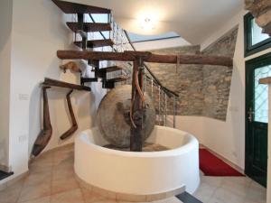 una scala in una casa con un grande vaso metallico di Apartment Frantoio by Interhome a Stellanello