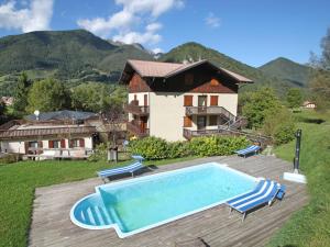 a villa with a swimming pool in front of a house at Apartment Lembondel-4 by Interhome in Tiarno di Sotto