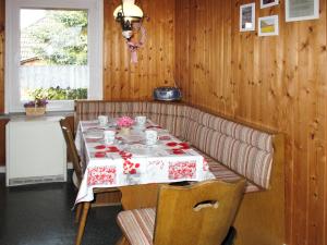 a dining room table with a red and white table cloth at Holiday Home Kaiser by Interhome in Garz