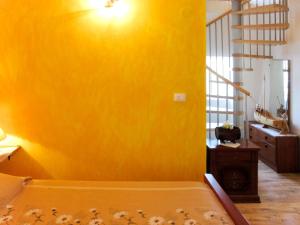 a bedroom with a yellow wall and a bed at Holiday Home Pinezici - RCA151 by Interhome in Marčana